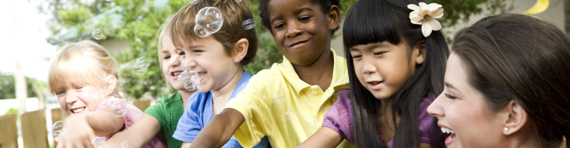 diverse group of preschool 5 year old children playing in daycare