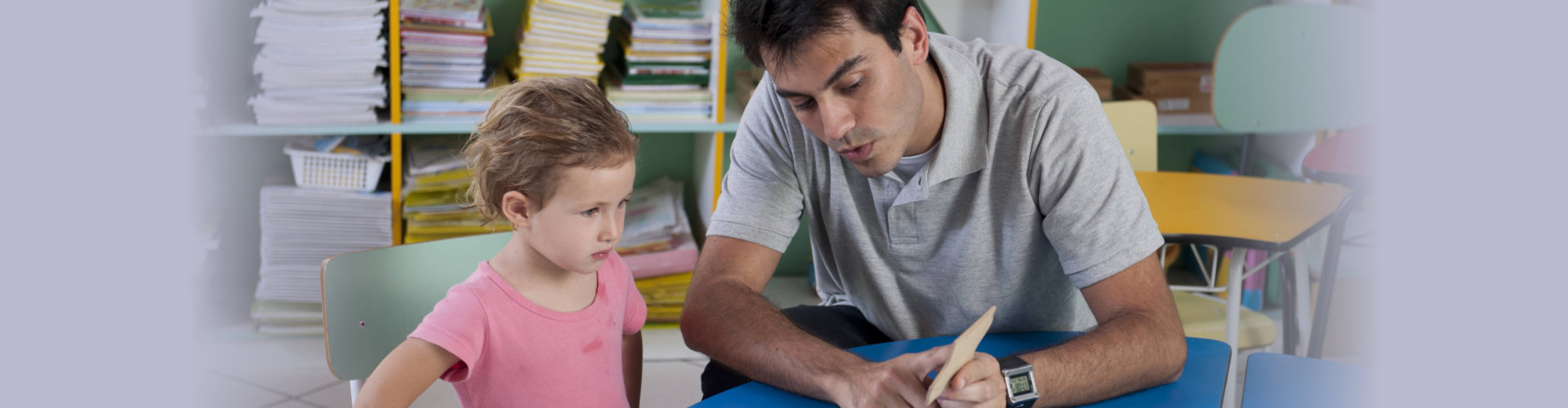 preschool teacher and child in the classroom counting