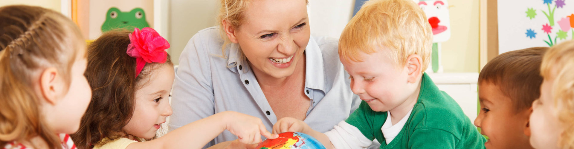 multicultural children hands on a globe